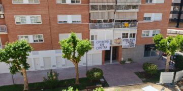 Pancartas en la calle Fuentenovilla en los balcones. Las viviendas en que se han convertido los locales están en la planta baja